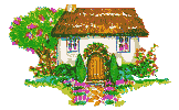 white cottage with thatched roof and floral foliage